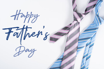Happy Father Day background concept with blue and pink necktie on white background with copy space for text.