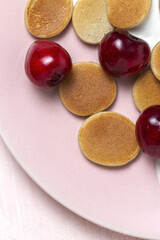 Homemade cereals mini pancake with yogurt, honey and strawberries on colorful background.