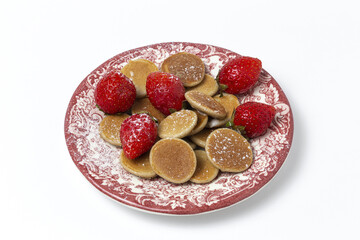 Homemade cereals mini pancake with yogurt, honey and strawberries on colorful background.