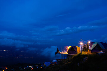The atmosphere of camping tent at night on a hill in the midst of cool weather, blue sky