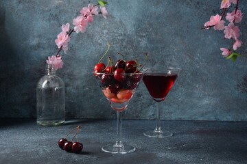 Sweet red and yellow cherries in two glasses. Cherry close-up in a glass with water drops. Summer sweet dessert