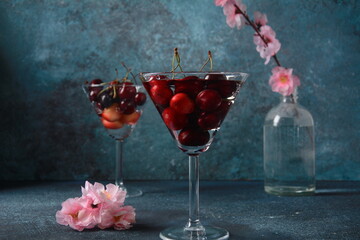 Sweet red and yellow cherries in two glasses. Cherry close-up in a glass with water drops. Summer sweet dessert