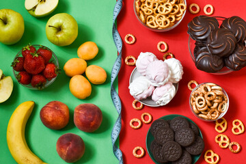 Healthy eating and junk food with measuring tape on a red-green background. The concept of choosing the right food. view from above.
