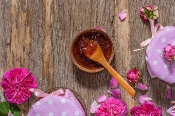 Homemade tea rose petal jam on a old wooden table. Top view