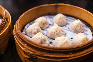 Steamed Xiao Long Bao (Soup Dumplings) in The Bamboo Basket. Served in Restaurant in Taipei, Taiwan.