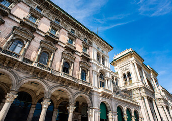 Fototapeta na wymiar Facade of Galleria Vittorio Emanuele II and Old Beautiful Building on Duomo Square (Piazza del Duomo) in Milan.