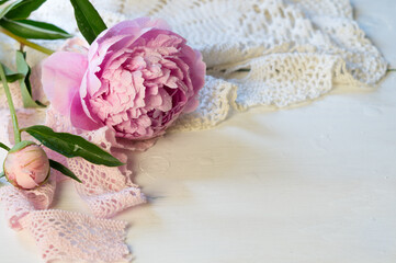 Beautiful pink peony on a white background with lace. Idea for postcards. Desktop Wallpaper. © IrinaBogach