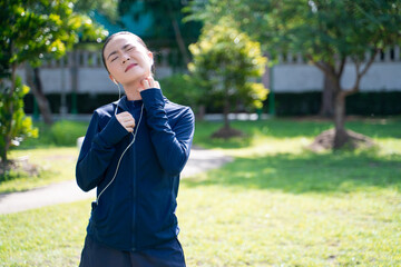 Portrait of Asian woman wearing earphones listening to music was sick with irritate itching her...