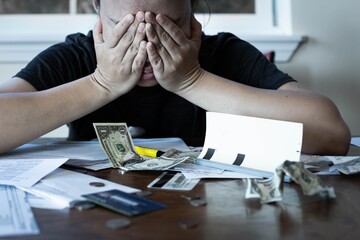 Stressed woman worrying about financial debt and monthly bills. Money crisis.
