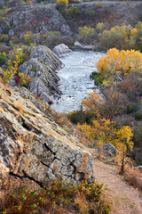 Landscape view from above on whitewater kayakers in Southern Bug river at autumn