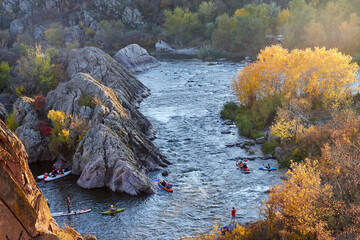 Landscape view from above on whitewater kayakers in Southern Bug river at autumn
