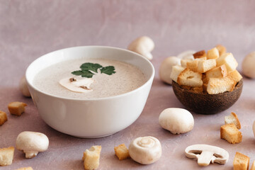 creamy mushroom cream soup with champignons serving in delicate pink colors