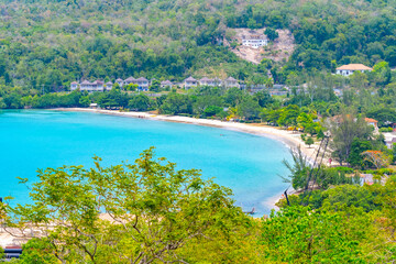 Aerial view of scenic beach landscape surrounded by lush greenery on north coast of Jamaica in...
