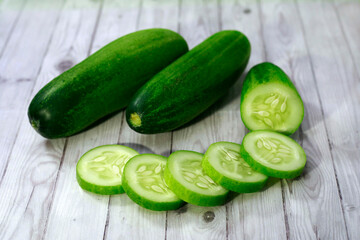 slices of cucumber  on wood texture background