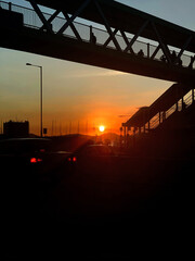 Fototapeta na wymiar Silhouette of city bridge, road, car in Hong Kong downtown district at sunset
