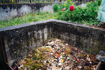 composted soil in stone compost at the garden