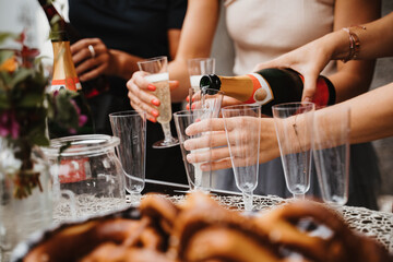 Friends celebrating party with rose champagne on festive day