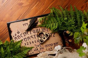 Mystic ritual with Ouija and candles. Devil's board concept, black magic or fortune telling rite with occult and esoteric symbols.