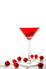 fresh red cherry juice in a wine glass with red cherries 