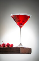 fresh red cherry juice in a wine glass with red cherries 