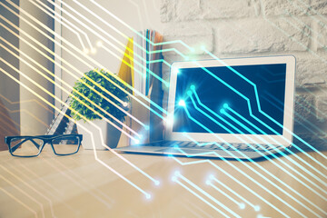 Double exposure of desktop computer and technology theme hologram. Concept of software development.