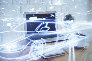 Desktop computer background in office with automobile hologram drawing. Multi exposure. Tech...