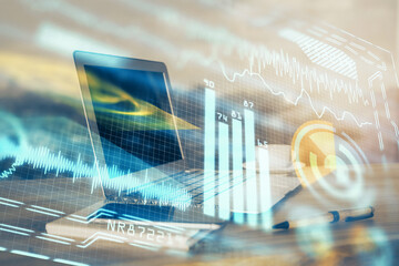 Computer on desktop in office with technology theme hologram. Multi exposure. Tech concept.