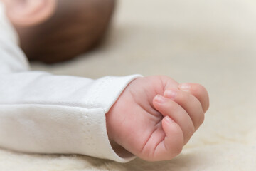 hands of a sleeping baby close up