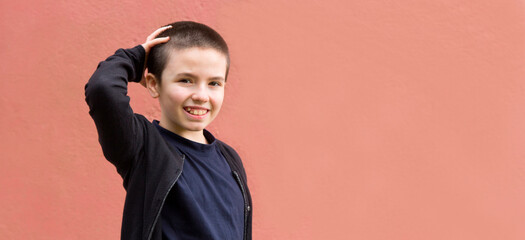 Teenager girl with short hair over pink wall laughing