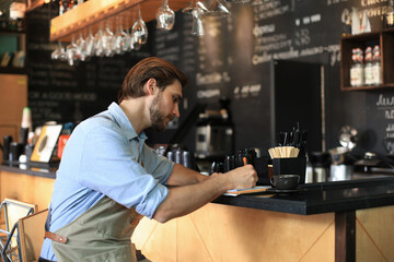 Fototapeta premium Small business owner working at his cafe.