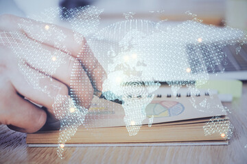 Double exposure of hands and notepad with business icons.