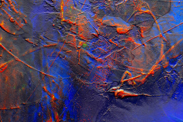 Close up detail of a acrylic painting with textures of dark blue, red and yellow