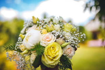Delicate wedding bouquet of pink roses and peonies
