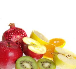  Sliced kiwi fruits, apple, lemon, orange, pomegranate on a white background.