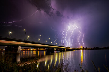 Huge thunderstorm over the city with the powerful lightnings in the sky