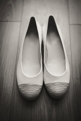 Morning of the bride, white shoes lying on the floor