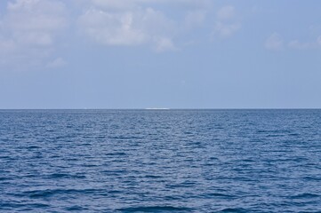 Distant view of a desert island in the Indian ocean (Ari Atoll, Maldives, Asia)