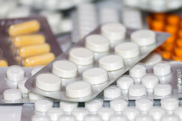 background of pills and capsules in blisters