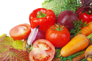 Colored vegetables. Tomatoes, cucumber, onions, peppers, carrots, beets, parsley on a white background