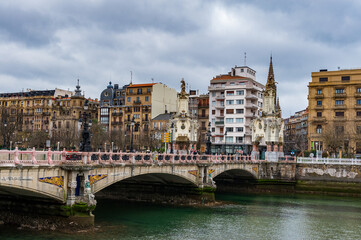 It's Maria Cristina Bridge over the river Urumea, San Sebastian, Spain. Bridge was inaugurated on the January 20, 1905