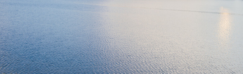 view of sky reflecting on rippled lake water surface texture banner