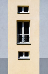 Fototapeta na wymiar Yellow / gray facade of a building. Block of flats.