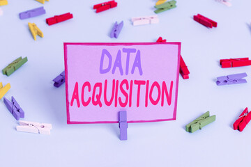 Writing note showing Data Acquisition. Business concept for way to obtain statistics that can be maneuvered digitally Colored clothespin papers empty reminder blue floor officepin