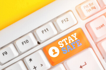 Conceptual hand writing showing Stay Safe. Concept meaning secure from threat of danger, harm or...