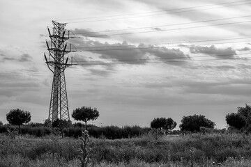High voltage tower at sunset. Black and white.