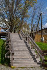 Fototapeta na wymiar Wooden stairs with railings leading down to riverside- Selective focus