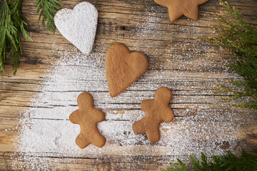 The concept of Christmas gingerbread love, lovers of gingerbread lie on a wooden background.