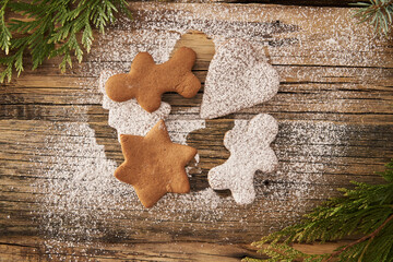 The concept of Christmas gingerbread love, lovers of gingerbread lie on a wooden background.