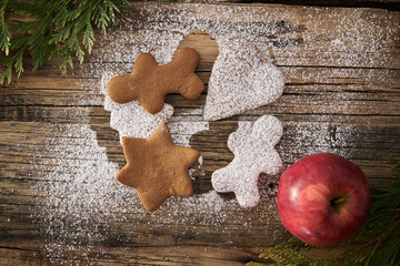 Christmas homemade gingerbread cookies and Christmas tree on a wooden background