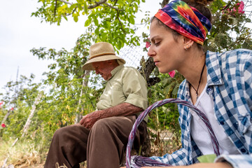 Grandfather and granddaughter cutting vegetables